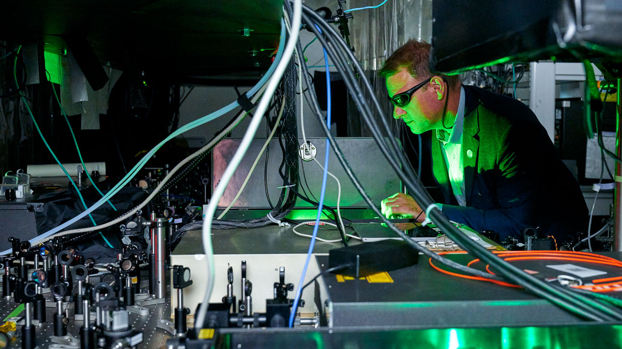 Chris Schaffer works with a laser configuration in his Weill Hall laboratory.
